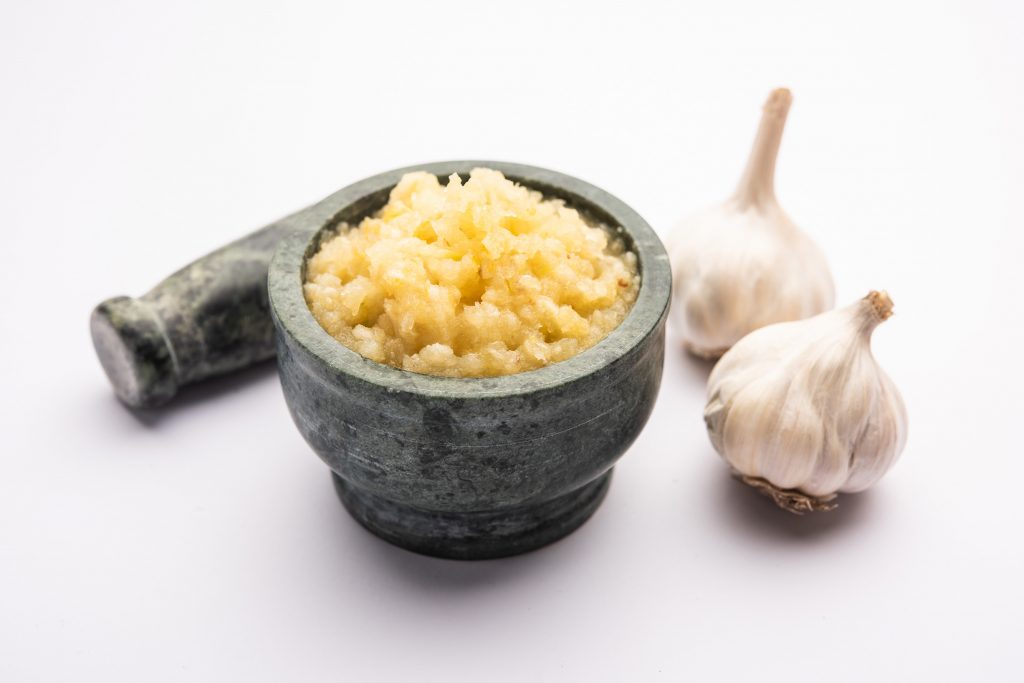 garlic paste lahsun puree with raw whole isolated white background selective focus