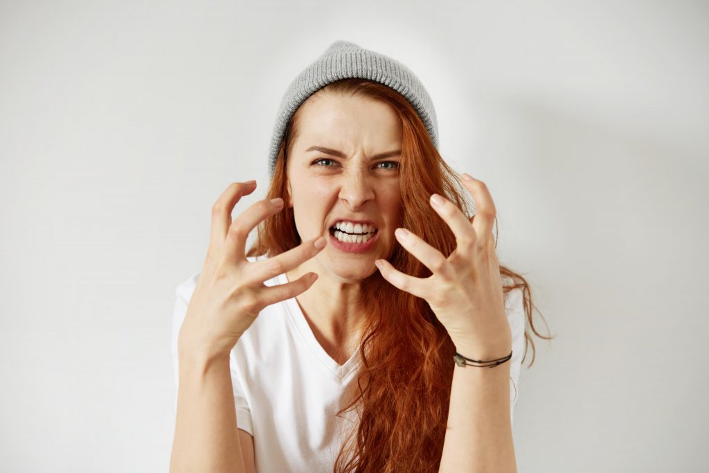 close up isolated portrait young annoyed angry woman holding hands furious gesture 1
