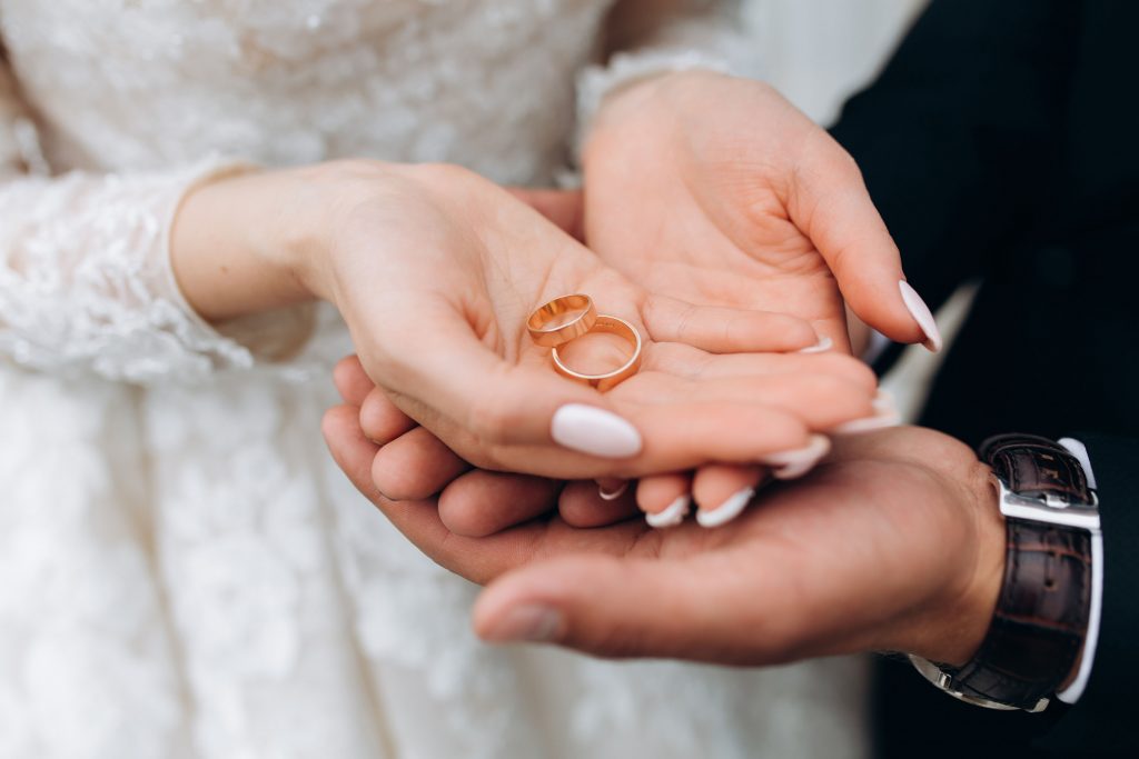 groom holds bride s hands where are two wedding rings