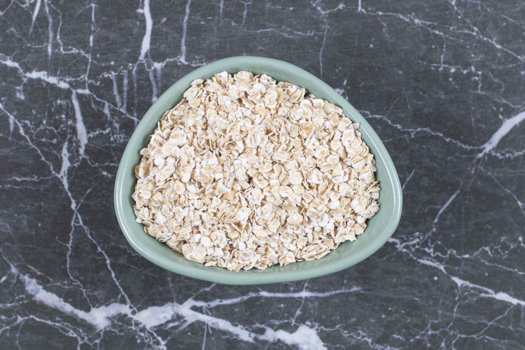 rolled oats oat flakes wooden bowl stone