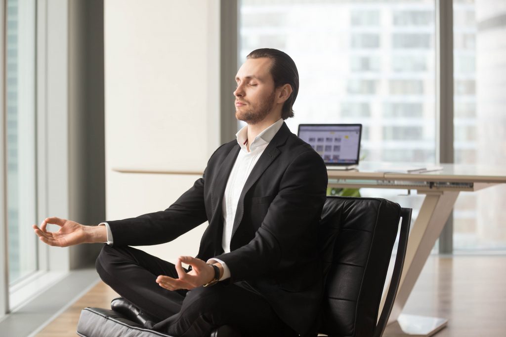 successful businessman meditating workplace